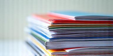 A stack of printed brochures and leaflets